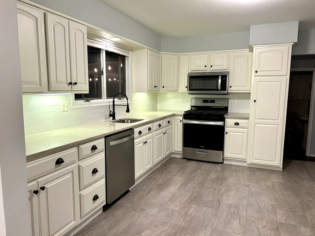After — white cabinets and LVP in the galley