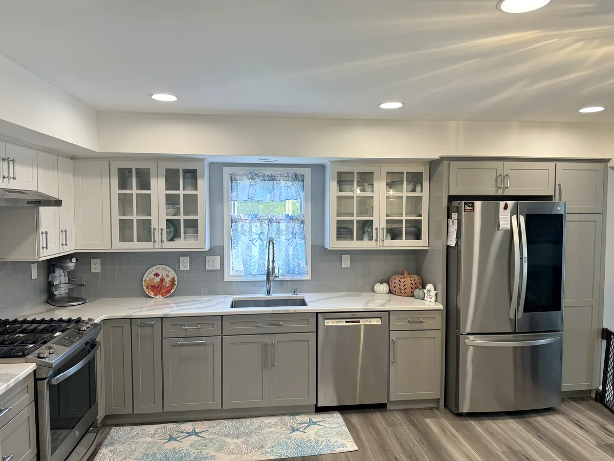 After — grey shaker cabinets, glass uppers, new counters