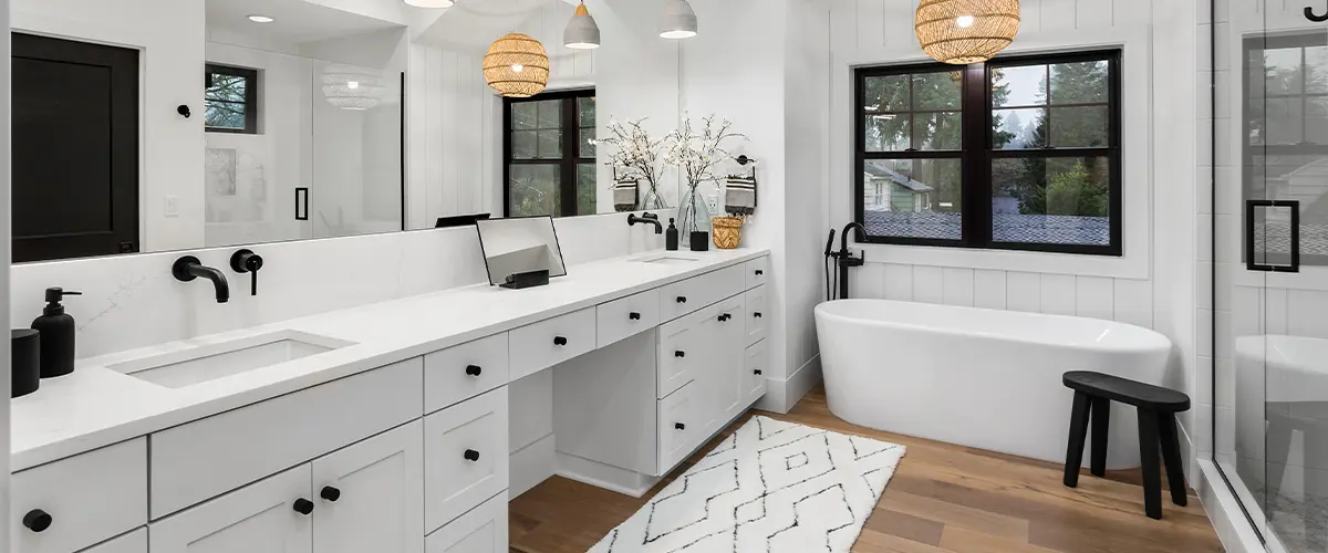 Modern bathroom remodeling, with double vanity, pendant lights, and freestanding bathtub.