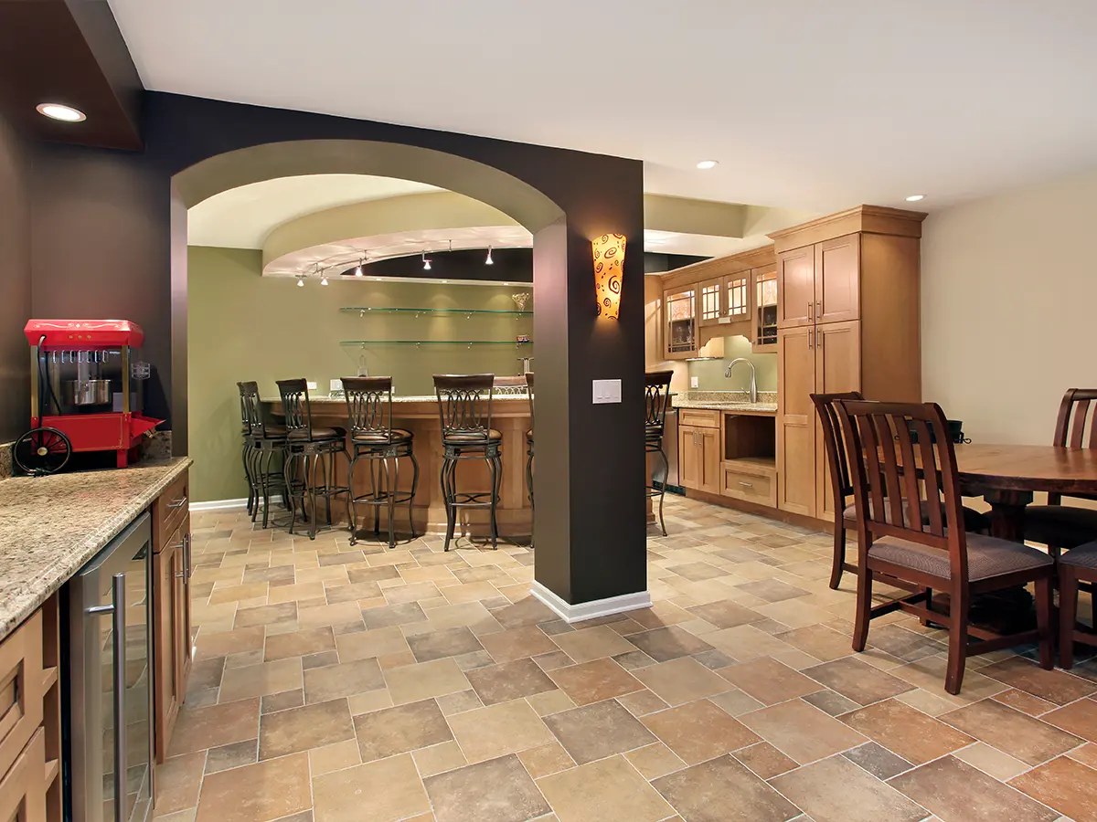 Remodeled basement with bar area, kitchen, and dining space