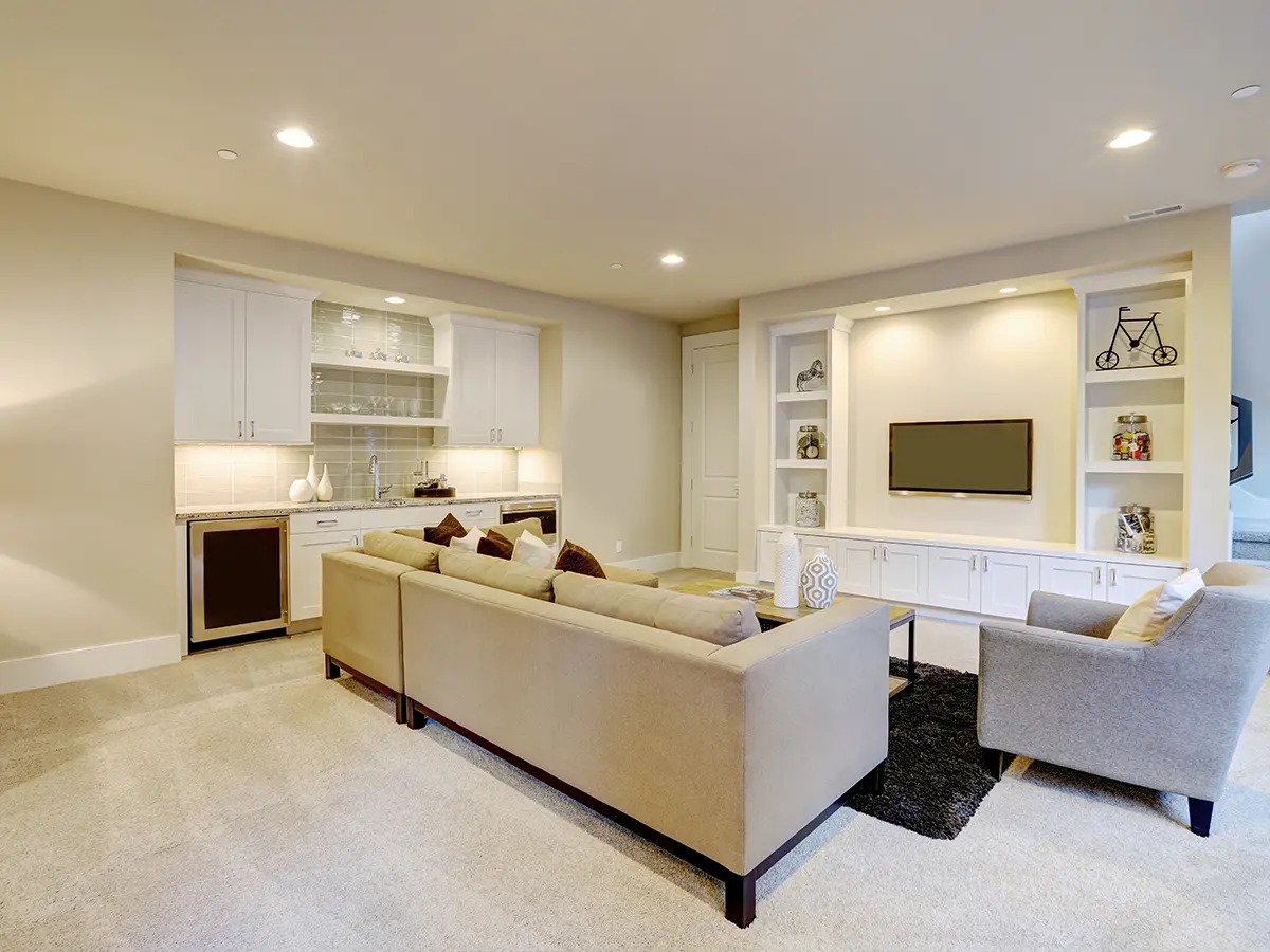 Cozy basement living area with built-in entertainment center and wet bar