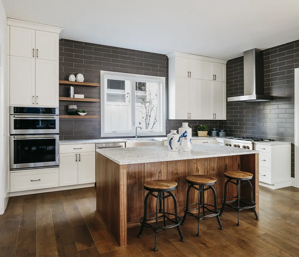 Contemporary kitchen with dark subway tile backsplash, wood island, and stainless steel appliances